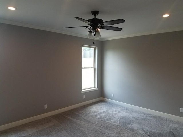 empty room featuring baseboards, ornamental molding, and carpet flooring