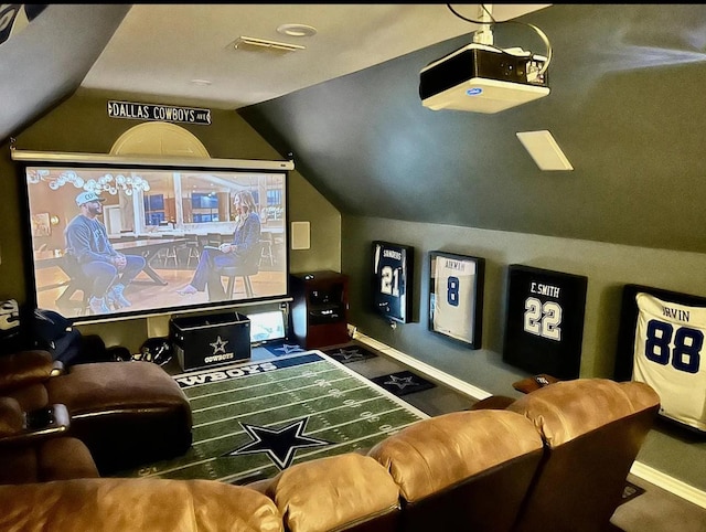 cinema featuring visible vents, lofted ceiling, and baseboards