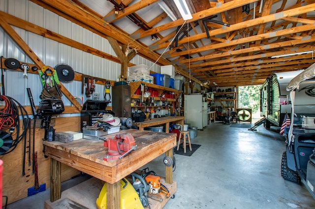 garage with a workshop area and metal wall