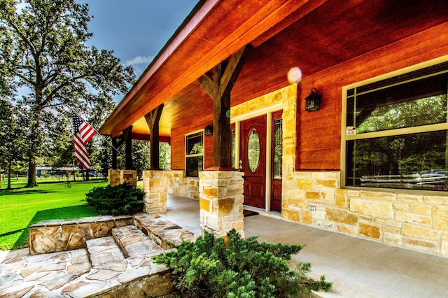 doorway to property with stone siding