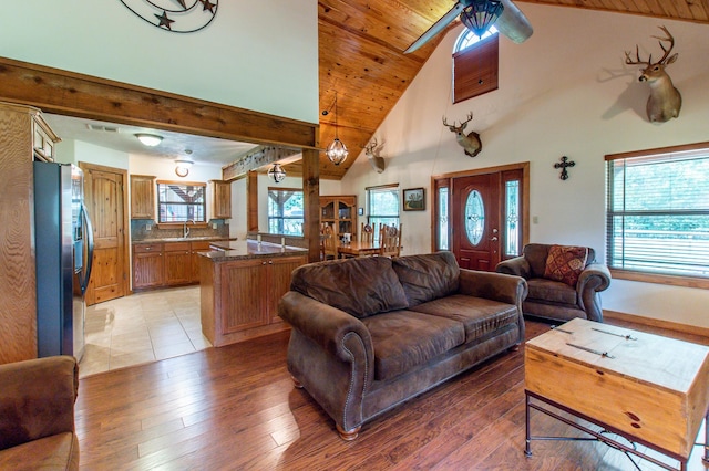 living area with visible vents, light wood-style flooring, wood ceiling, and ceiling fan