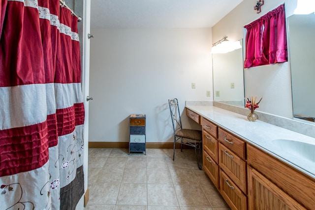 bathroom featuring tile patterned floors, baseboards, a shower with shower curtain, and vanity