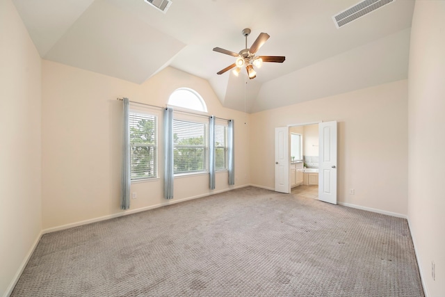 interior space featuring light carpet, visible vents, baseboards, and lofted ceiling