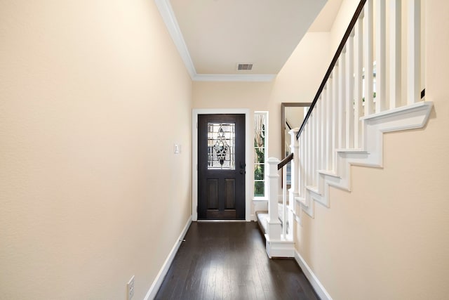 foyer entrance with visible vents, ornamental molding, dark wood-style floors, baseboards, and stairs