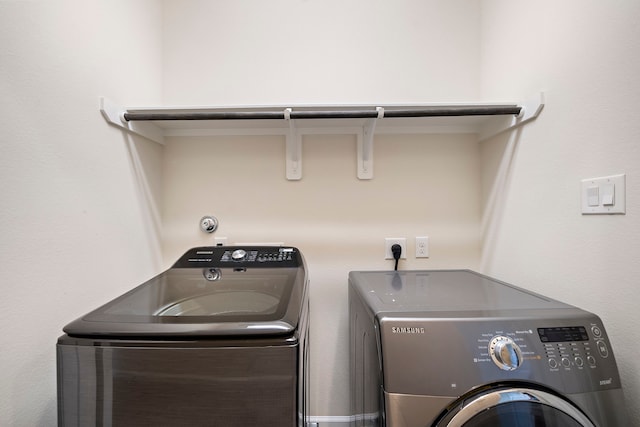 laundry room featuring separate washer and dryer and laundry area