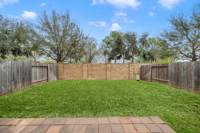 view of yard with a fenced backyard