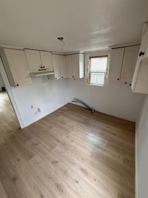 clothes washing area featuring light wood-style floors