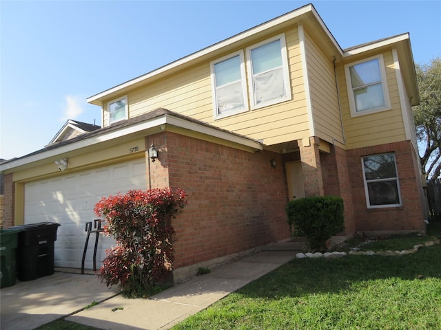 view of front facade with brick siding and concrete driveway