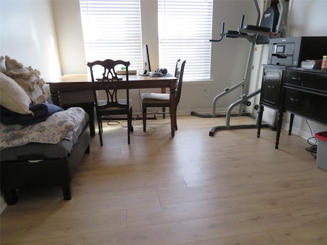 dining room featuring baseboards and light wood-type flooring