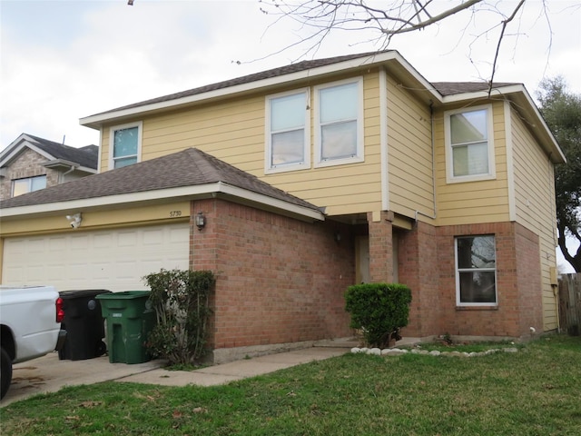 view of front facade featuring brick siding, a garage, a shingled roof, and a front yard