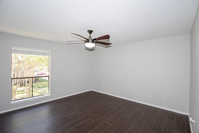 unfurnished room with baseboards, a textured ceiling, dark wood finished floors, and a ceiling fan