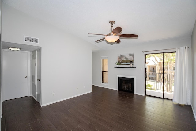 unfurnished living room featuring visible vents, baseboards, dark wood-type flooring, and a fireplace