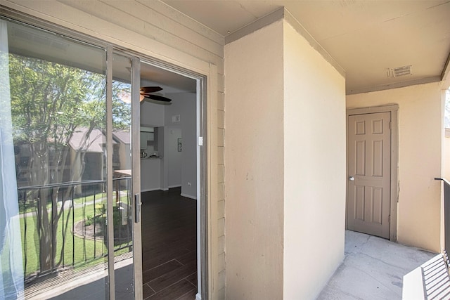 view of exterior entry featuring visible vents and stucco siding