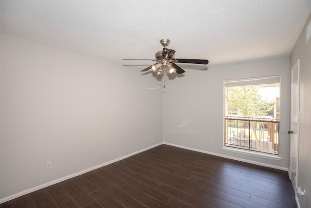 spare room featuring ceiling fan, baseboards, a textured ceiling, and dark wood-style floors