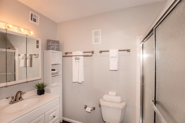 bathroom with visible vents, vanity, toilet, and a shower stall