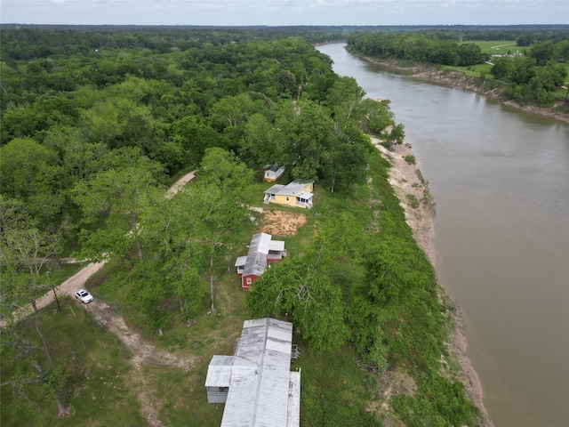 aerial view featuring a wooded view and a water view