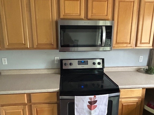 kitchen featuring light countertops and appliances with stainless steel finishes