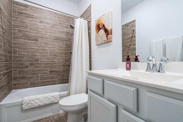 full bathroom featuring vanity, toilet, wood finished floors, and shower / tub combo