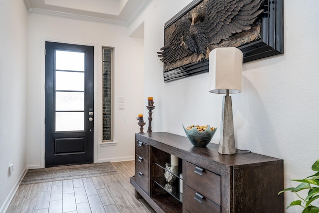 foyer entrance with crown molding, baseboards, and wood tiled floor