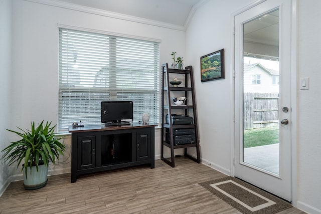 home office with light wood finished floors, crown molding, and baseboards