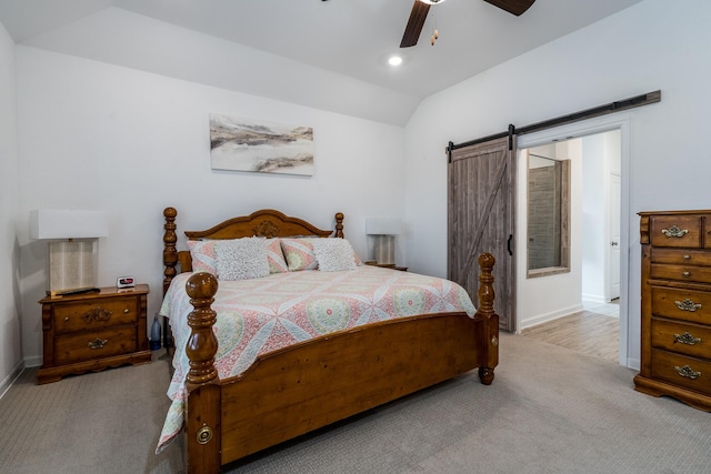 carpeted bedroom with a ceiling fan, recessed lighting, a barn door, baseboards, and vaulted ceiling