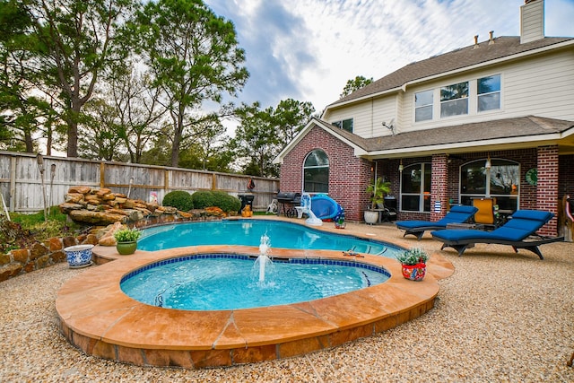 view of swimming pool with a patio area, a fenced in pool, and fence