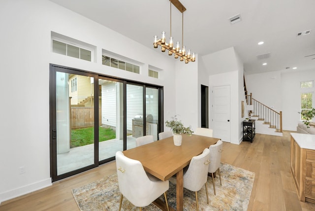 dining space featuring light wood-type flooring, visible vents, recessed lighting, a chandelier, and stairs