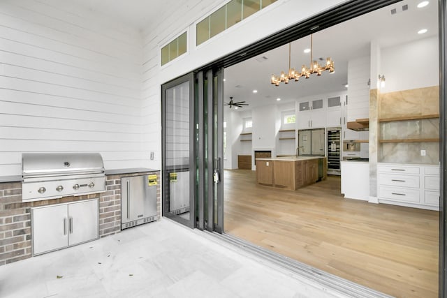 view of patio / terrace with a sink, area for grilling, visible vents, and a grill