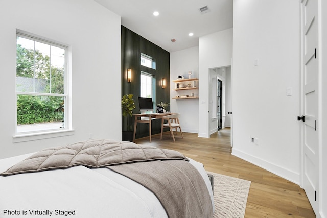 bedroom featuring recessed lighting, visible vents, light wood-style flooring, and baseboards