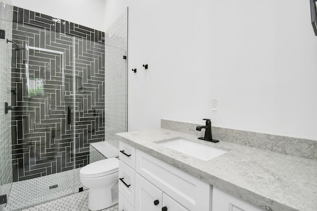 full bath featuring tile patterned flooring, toilet, tiled shower, and vanity