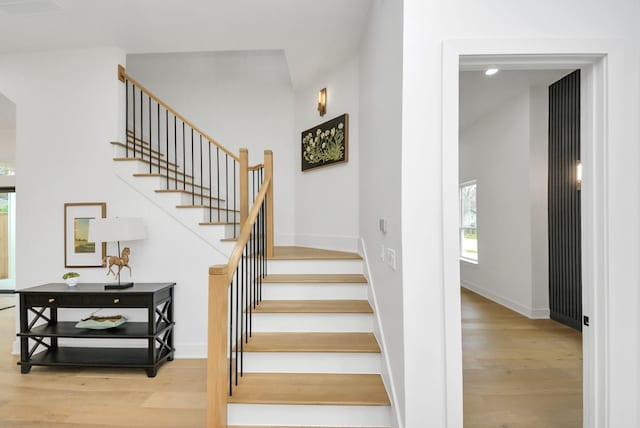 stairway with baseboards and wood finished floors