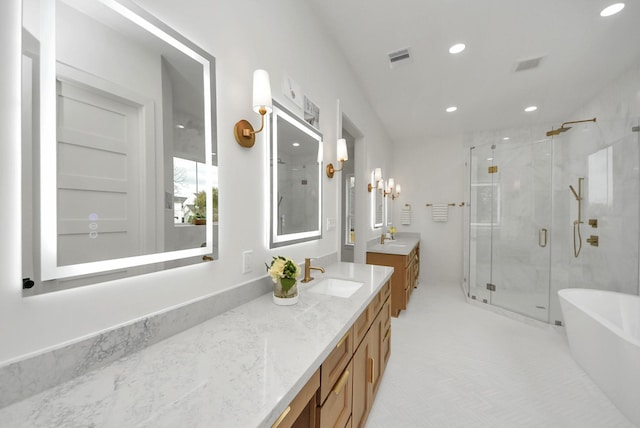 full bath with visible vents, a freestanding tub, recessed lighting, a shower stall, and vanity