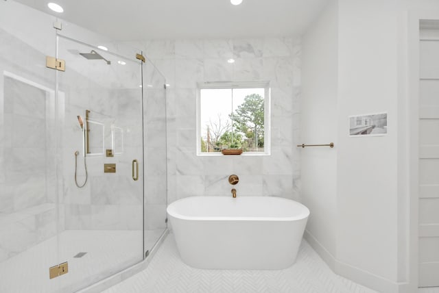 full bathroom featuring recessed lighting, a marble finish shower, and a freestanding bath