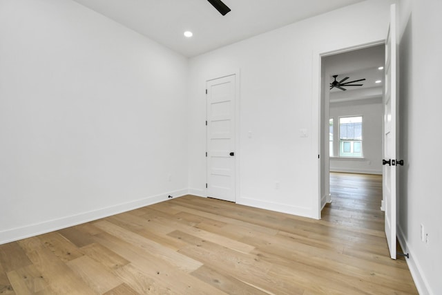 empty room with recessed lighting, a ceiling fan, light wood-type flooring, and baseboards