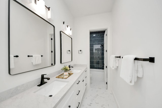 full bathroom with double vanity, walk in shower, marble finish floor, and a sink