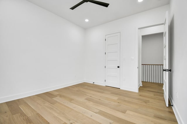 unfurnished room with recessed lighting, baseboards, and light wood-style floors