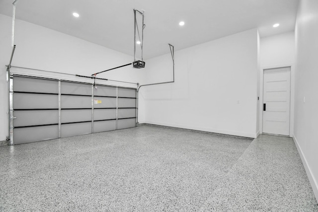 garage with recessed lighting, a garage door opener, and baseboards