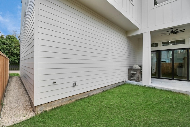 view of home's exterior featuring a ceiling fan, a yard, and a patio area