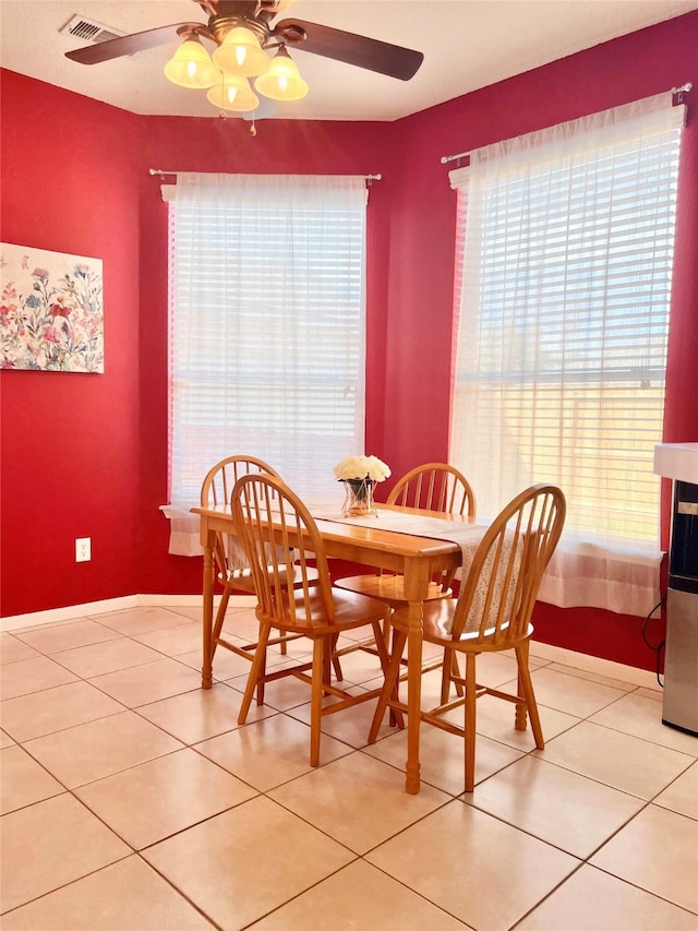 dining space featuring light tile patterned floors, visible vents, and ceiling fan