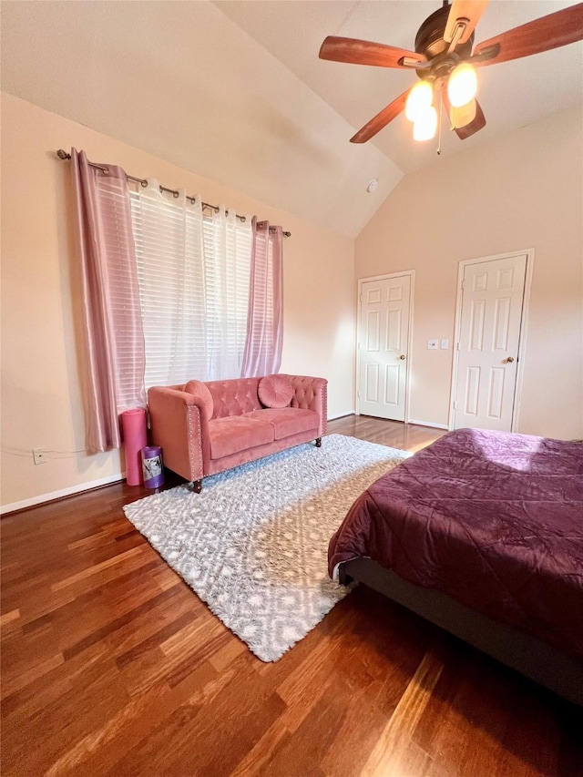 bedroom with a ceiling fan, lofted ceiling, wood finished floors, and baseboards