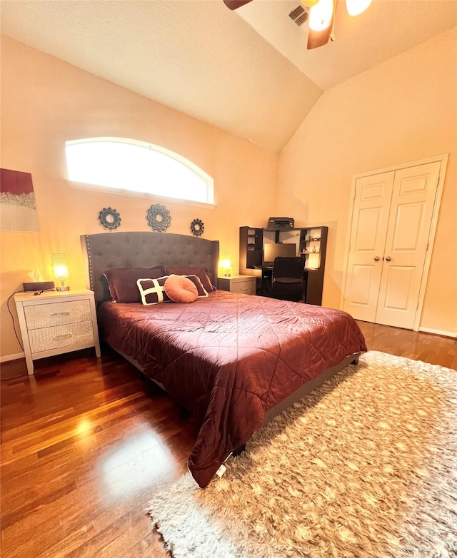 bedroom featuring visible vents, ceiling fan, lofted ceiling, and wood finished floors