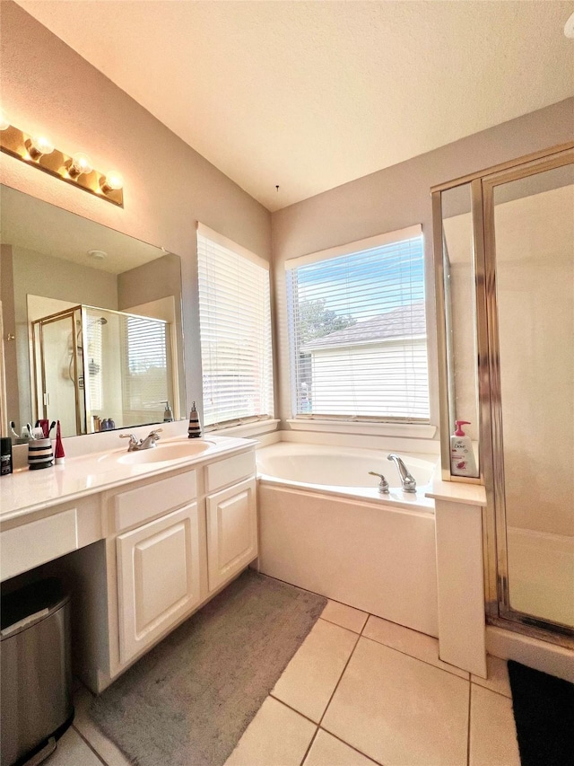 full bathroom featuring vanity, a garden tub, a stall shower, and tile patterned floors