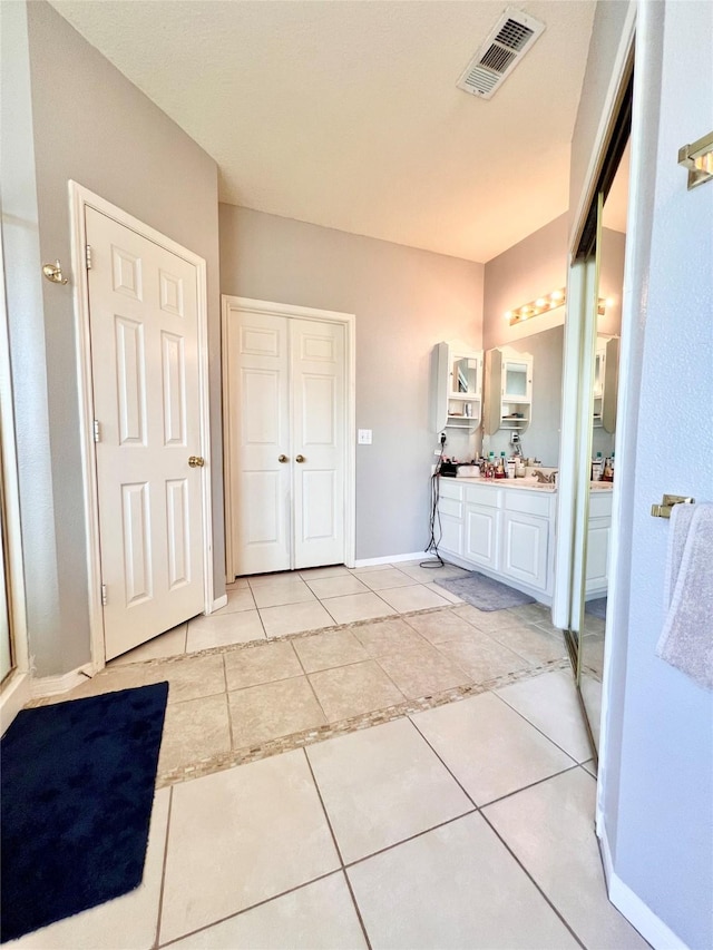 full bath featuring visible vents, baseboards, vanity, and tile patterned flooring