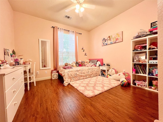 bedroom with wood finished floors, visible vents, and ceiling fan