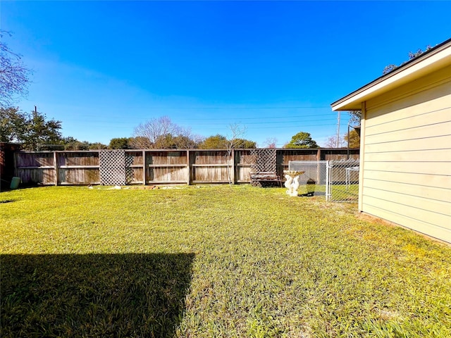 view of yard with a fenced backyard