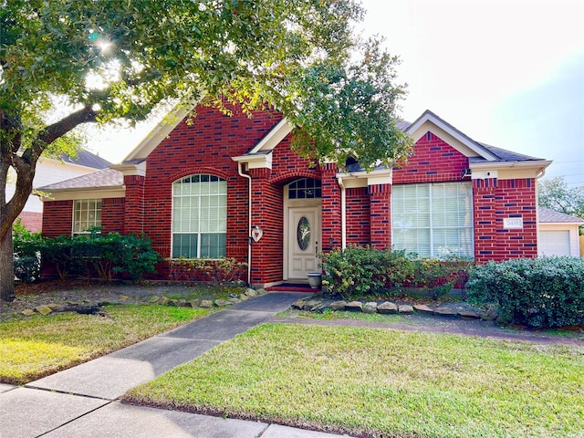 ranch-style house featuring brick siding and a front lawn