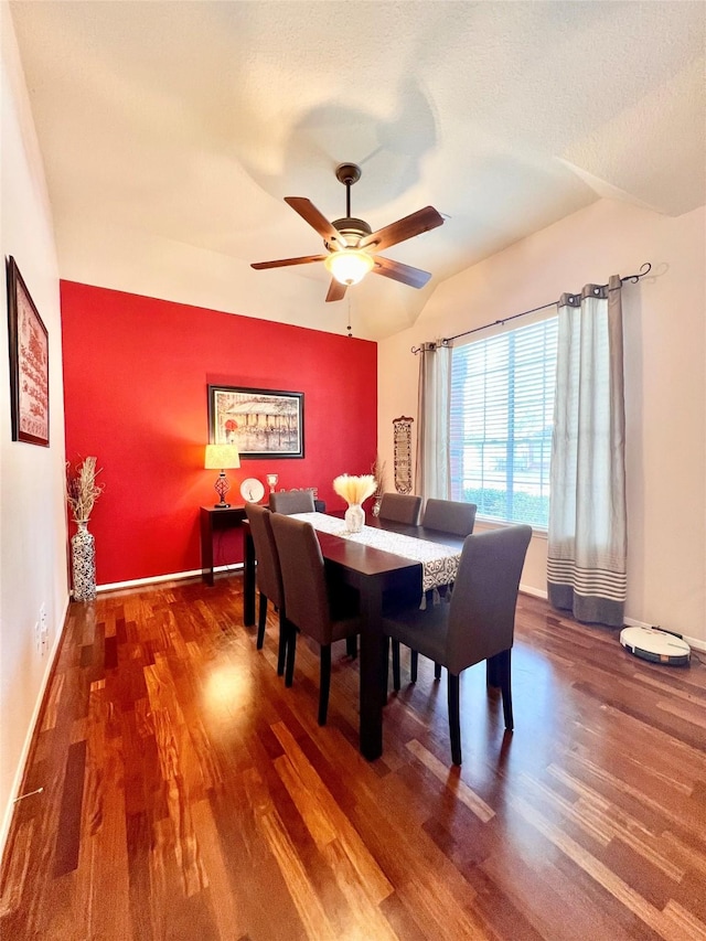 dining area with a textured ceiling, a ceiling fan, baseboards, and wood finished floors