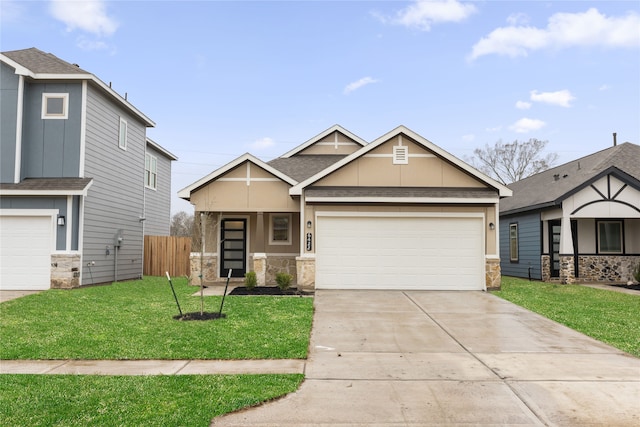 view of front facade with a front yard, fence, driveway, roof with shingles, and a garage