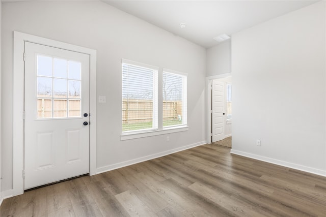 entryway featuring baseboards and wood finished floors