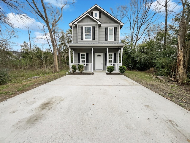 view of front facade with board and batten siding and a porch